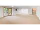 Spacious basement features sliding glass doors, a staircase, and painted walls at 4983 Odins Way, Marietta, GA 30068