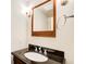 Bathroom features a wood mirror, vanity and granite countertop with a sink and chrome hardware at 4983 Odins Way, Marietta, GA 30068