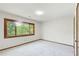 Bright bedroom with a large window offering a green view and neutral carpet at 4983 Odins Way, Marietta, GA 30068