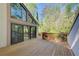Large wooden deck with railing and view of wooded backyard at 4983 Odins Way, Marietta, GA 30068