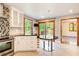 Bright kitchen features stainless steel appliances, white cabinets and a modern island table at 4983 Odins Way, Marietta, GA 30068