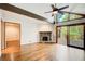 Open living room with stone fireplace, wood beam, and access to deck at 4983 Odins Way, Marietta, GA 30068