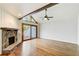 Living room with stone fireplace, wood floors, and sliding glass door to deck at 4983 Odins Way, Marietta, GA 30068