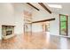 Spacious living room with vaulted ceilings, wooden beams, stone fireplace, and hardwood floors at 4983 Odins Way, Marietta, GA 30068