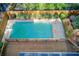 Aerial view of backyard pool with wood fence and deck, plus greenery along the perimeter at 4983 Odins Way, Marietta, GA 30068