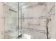 Modern shower with grey tiling, glass enclosure, multiple shower heads and a built-in bench at 4983 Odins Way, Marietta, GA 30068