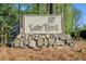 Community entrance sign for Lake Sjord, showcasing a stone base and wooded surroundings at 4983 Odins Way, Marietta, GA 30068