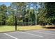Outdoor basketball court with well-maintained surface and hoop, adjacent to a volleyball court at 730 Denmead Se Ml, Marietta, GA 30067