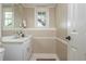 Half bathroom featuring a single sink vanity and tiled floors at 730 Denmead Se Ml, Marietta, GA 30067