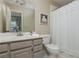 Bathroom featuring a single sink vanity, toilet, and tub with shower at 730 Denmead Se Ml, Marietta, GA 30067