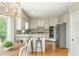 Bright kitchen featuring stainless steel appliances, custom cabinets, granite countertops, and hardwood flooring at 730 Denmead Se Ml, Marietta, GA 30067