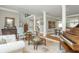 The well-lit living room features tile floors, column accents, stylish furnishings, and an adjoining dining area at 730 Denmead Se Ml, Marietta, GA 30067