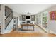 Cozy living room with a fireplace, built-in shelves, and large windows offering great views of the surrounding landscape at 730 Denmead Se Ml, Marietta, GA 30067