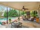 Covered patio with ceiling fan and a view of the pool and landscaped backyard at 730 Denmead Se Ml, Marietta, GA 30067