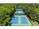 Aerial view of pristine tennis courts surrounded by lush greenery, perfect for active residents at 730 Denmead Se Ml, Marietta, GA 30067