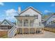 Back of house view showcasing an elevated porch and stairs leading to the backyard and driveway at 3055 Alston Dr, Decatur, GA 30032