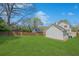 Expansive backyard featuring a lush green lawn, detached garage, and privacy fence at 3055 Alston Dr, Decatur, GA 30032