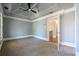 Bright bedroom with tray ceilings, soft carpet and ample natural light from a nearby window at 3055 Alston Dr, Decatur, GA 30032
