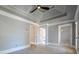Spacious bedroom with a tray ceiling, carpet, and multiple doorways to adjacent rooms at 3055 Alston Dr, Decatur, GA 30032