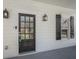 Close-up of the front door with sidelights, exterior lanterns, and decorative black shutters at 3055 Alston Dr, Decatur, GA 30032