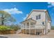 View of the home's exterior, showcasing a covered porch, manicured landscaping, and a well-maintained yard at 3055 Alston Dr, Decatur, GA 30032