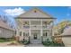 Charming two-story home featuring a double porch, beautiful landscaping, and a classic architectural design at 3055 Alston Dr, Decatur, GA 30032