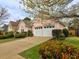 Charming exterior with a well-manicured lawn, lush landscaping, and a two-car garage at 4103 Christacy Way, Marietta, GA 30066