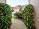 View of the charming brick home with a two-car garage framed by blooming camellias at 4103 Christacy Way, Marietta, GA 30066