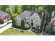 Aerial view of a beautiful home with landscaped grounds and a well-manicured lawn at 12350 Edenwilde Dr, Roswell, GA 30075