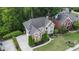 Aerial view of a house with well-kept landscaping, lawn and a driveway at 12350 Edenwilde Dr, Roswell, GA 30075