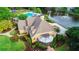 An aerial view showcasing the home's landscaped yard, lake and community pool with playground at 12350 Edenwilde Dr, Roswell, GA 30075