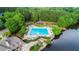 Aerial view of community pool and playground surrounded by lush trees at 12350 Edenwilde Dr, Roswell, GA 30075