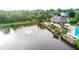 Aerial view of community clubhouse, swimming pool, and pond with fountain feature at 12350 Edenwilde Dr, Roswell, GA 30075