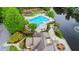 An aerial view featuring the community pool, a lake with a fountain, landscaping, and a playground at 12350 Edenwilde Dr, Roswell, GA 30075