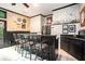 Stylish bar area with ample seating, white brick accent wall, and drink storage at 12350 Edenwilde Dr, Roswell, GA 30075