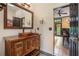 Rustic bathroom with a wooden vanity, bronze sink, and stylish lighting fixtures at 12350 Edenwilde Dr, Roswell, GA 30075