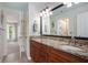 Bathroom featuring double sinks, granite countertops and a walk-in shower at 12350 Edenwilde Dr, Roswell, GA 30075