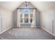 Cozy room with neutral walls, carpet, a window and large window offering natural light at 12350 Edenwilde Dr, Roswell, GA 30075