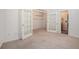 Versatile bonus room featuring French doors, carpet, and neutral wall color at 12350 Edenwilde Dr, Roswell, GA 30075
