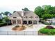 Community clubhouse featuring covered seating area, brick accents, landscaped grounds, and nearby pool at 12350 Edenwilde Dr, Roswell, GA 30075