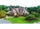 Community clubhouse with manicured lawn, sunroom, and walkway at 12350 Edenwilde Dr, Roswell, GA 30075