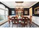 Formal dining room featuring wainscoting, navy blue textured wallpaper and chandelier at 12350 Edenwilde Dr, Roswell, GA 30075