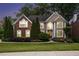 Charming two-story home with stone and stucco exterior, manicured lawn, and professional landscaping at 12350 Edenwilde Dr, Roswell, GA 30075