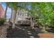 Back exterior view of home showcasing a multi-tiered deck and landscaped yard at 12350 Edenwilde Dr, Roswell, GA 30075