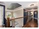 Upstairs hallway with open views of the foyer and wrought iron railings at 12350 Edenwilde Dr, Roswell, GA 30075