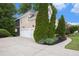 Charming home exterior with a well-maintained lawn and three-car garage at 12350 Edenwilde Dr, Roswell, GA 30075