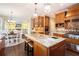 Gourmet kitchen features granite countertops, stainless steel appliances, and views of living spaces at 12350 Edenwilde Dr, Roswell, GA 30075