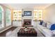Cozy living room featuring a fireplace, built-in shelving, and comfortable seating at 12350 Edenwilde Dr, Roswell, GA 30075