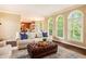 Bright living room with large windows, hardwood floors and comfortable seating open to the kitchen at 12350 Edenwilde Dr, Roswell, GA 30075