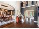 Stunning living room featuring hardwood floors, staircase, and an elegant dining room at 12350 Edenwilde Dr, Roswell, GA 30075
